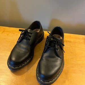 Dr. Martens black lace ups.